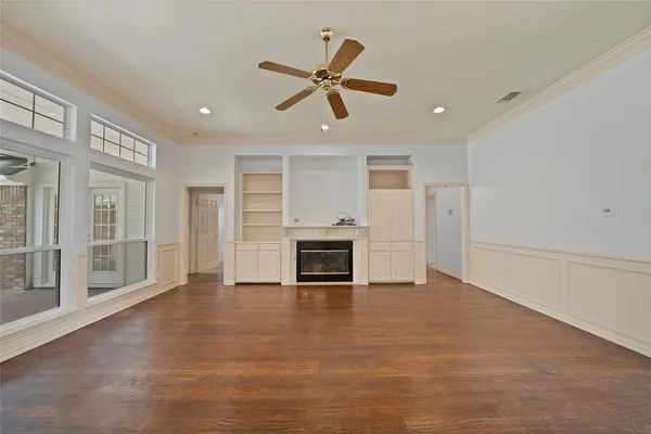 a view of an empty room with a fireplace and a window