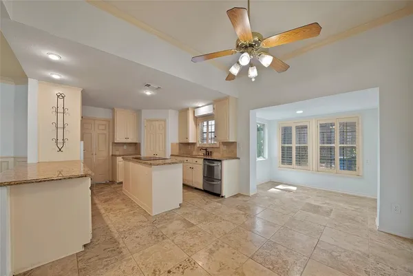 a open kitchen with cabinets stove and refrigerator