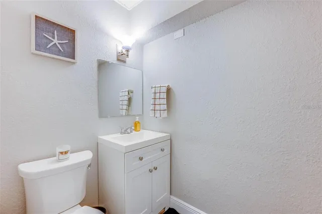 a bathroom with a sink toilet and a mirror