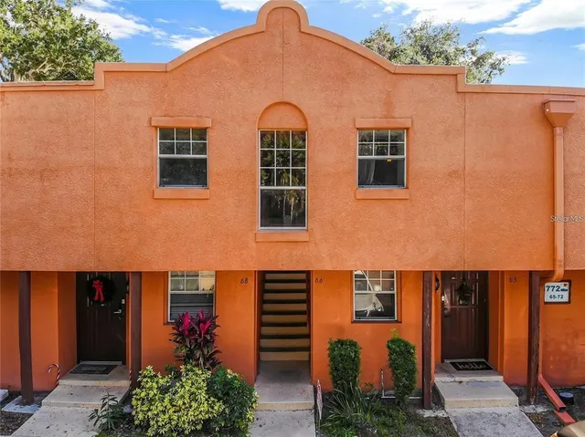 a view of a blue house with large windows