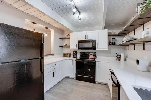 a kitchen with stainless steel appliances a refrigerator sink and microwave