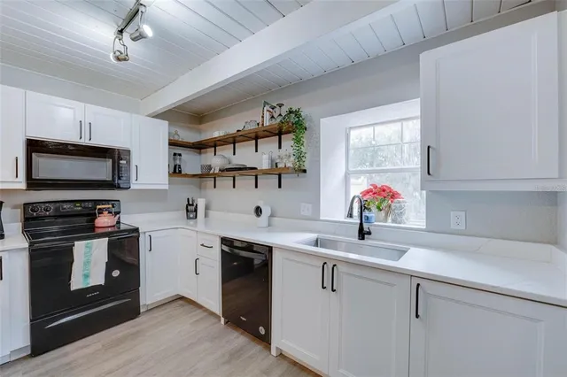 a kitchen with a sink cabinets and stainless steel appliances