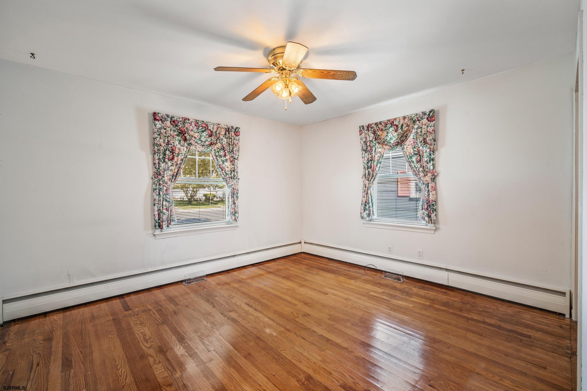 161 Coolidge Avenue Absecon, NJ 08201 - Photo 14 of 26 wooden floor in an empty room with a window