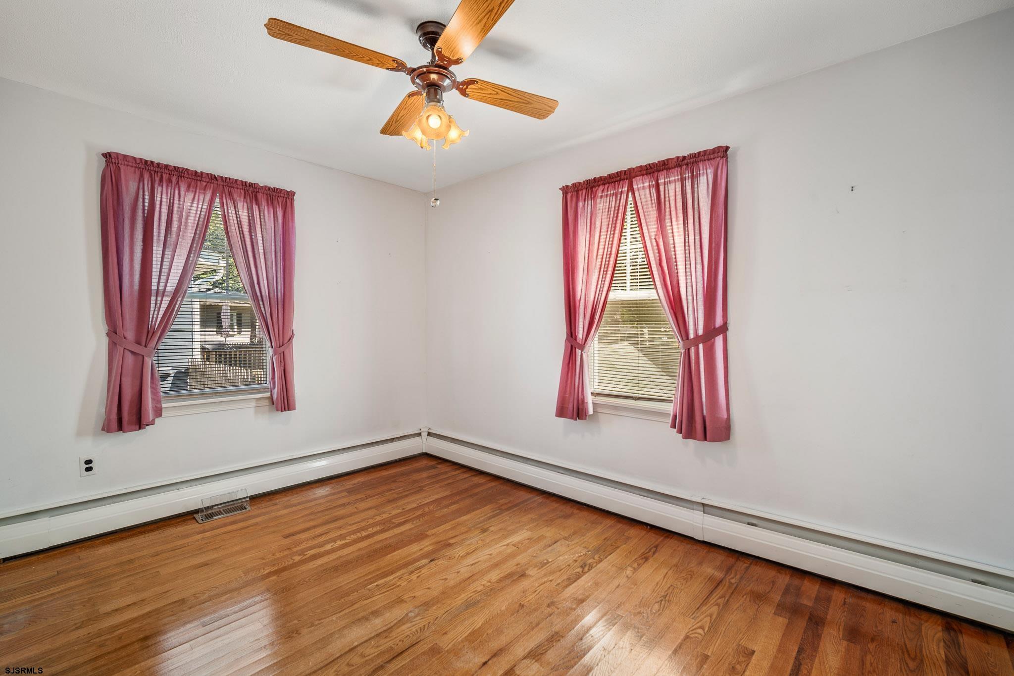 161 Coolidge Avenue Absecon, NJ 08201 - Photo 15 of 26 a view of a room with window a ceiling fan and wooden floor