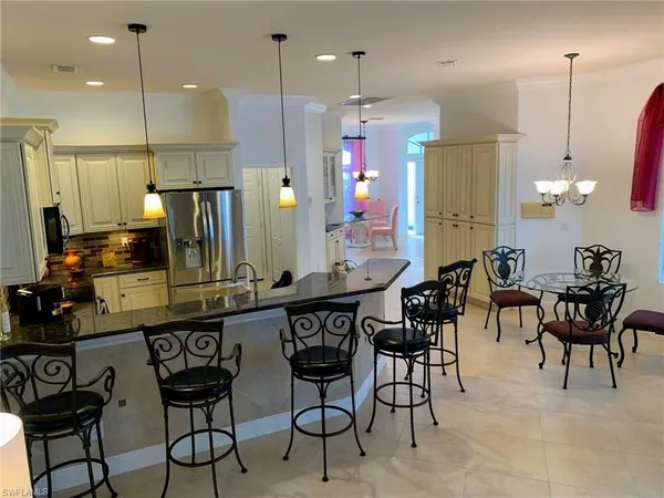 an open kitchen with a table and chairs in it