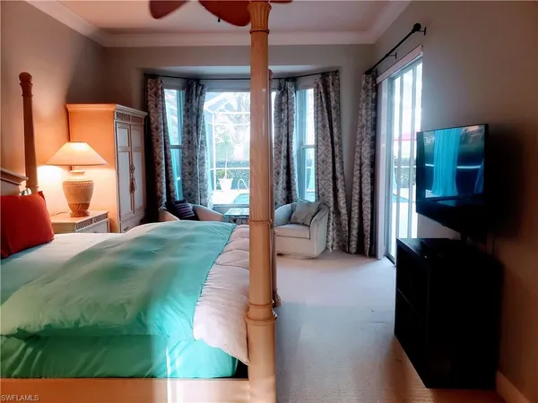 a spacious bedroom with a bed and a large window