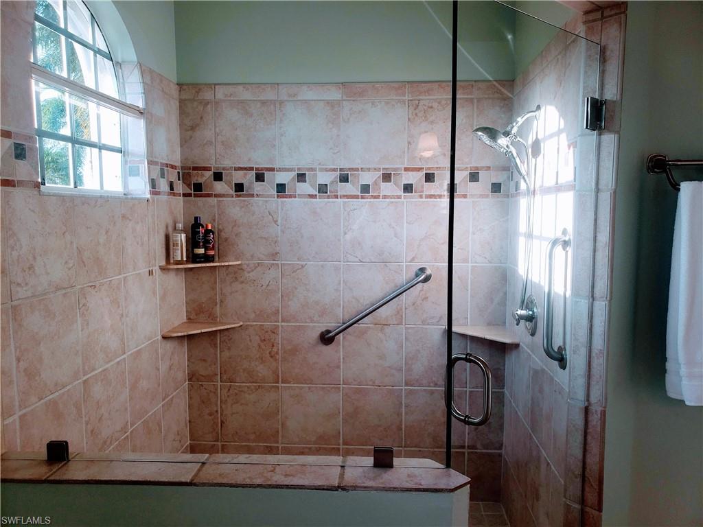 8906 Lely Island Circle Naples, FL 34113 - Photo 19 of 36 a bathroom with a shower