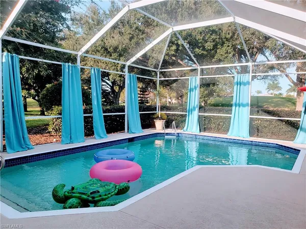 a view of a backyard with table and chairs and potted plants