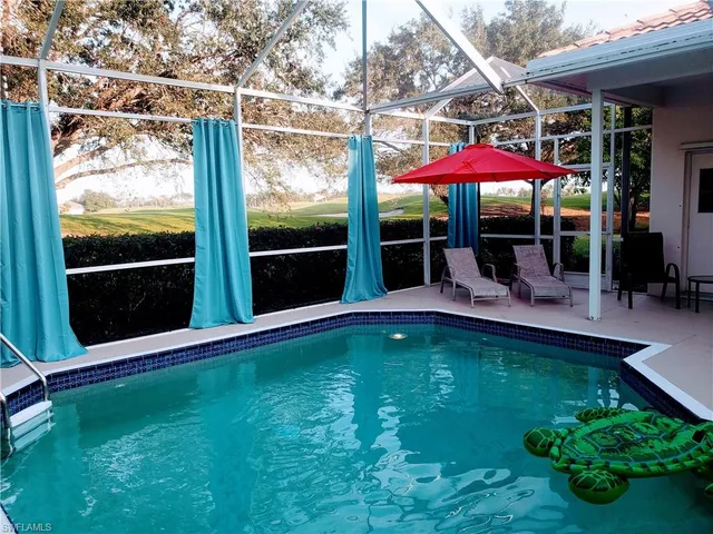 an outdoor space with swimming pool and furniture