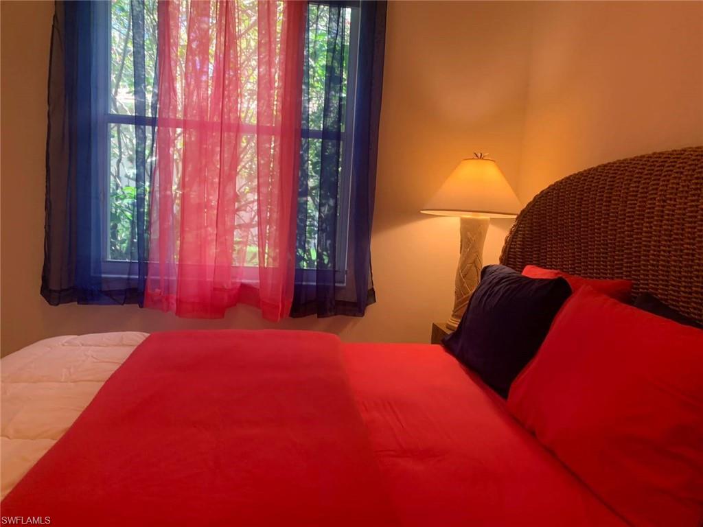 8906 Lely Island Circle Naples, FL 34113 - Photo 26 of 36 a bedroom with a bed and a window