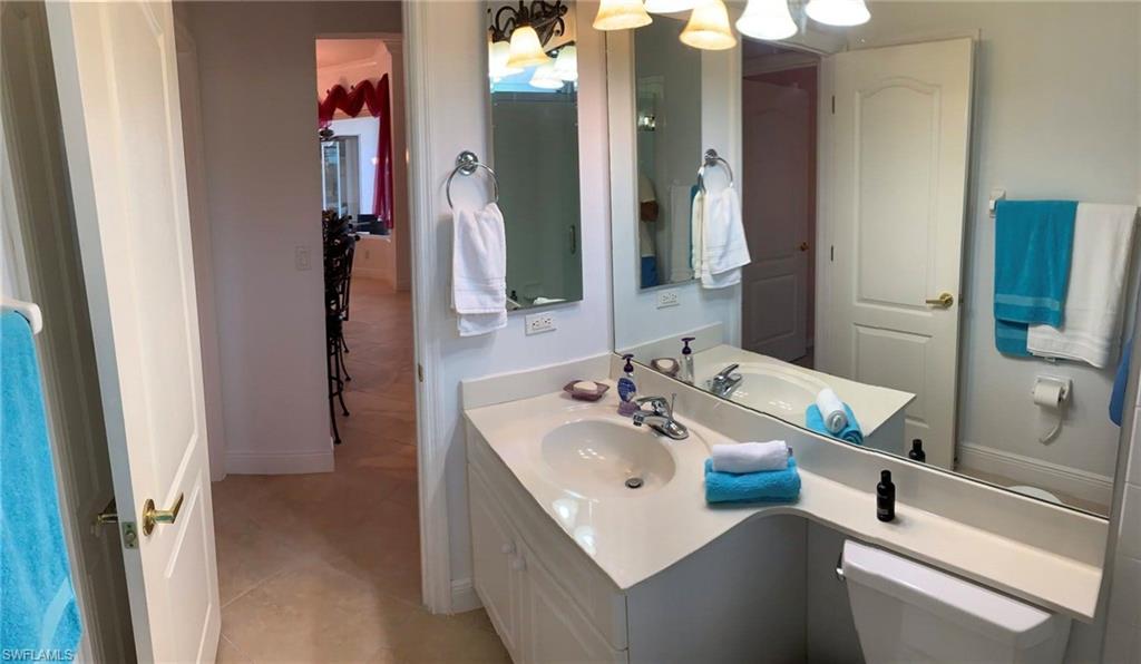 8906 Lely Island Circle Naples, FL 34113 - Photo 29 of 36 a bathroom with a sink vanity granite tub and shower