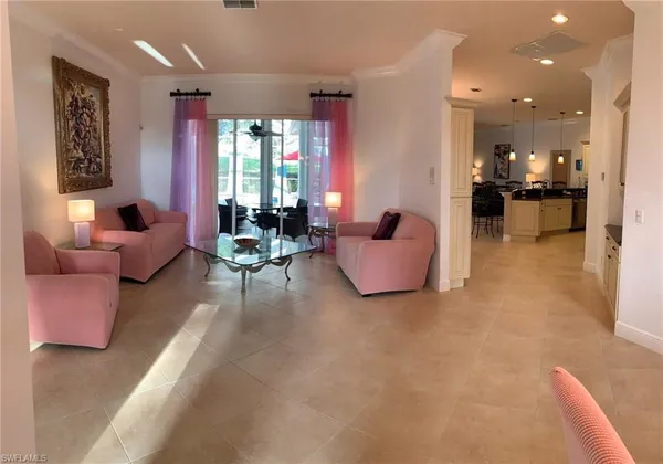 a living room with furniture and kitchen view
