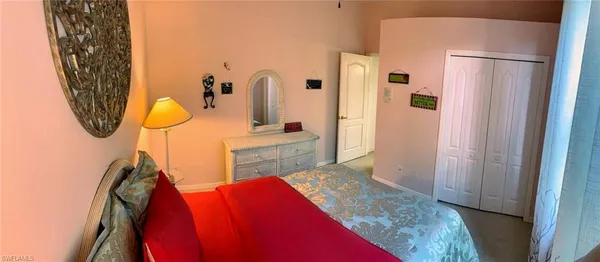 a view of walk in closet with rug and wall