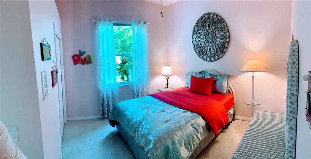 8906 Lely Island Circle Naples, FL 34113 - Photo 32 of 36 a bedroom with bed and a window