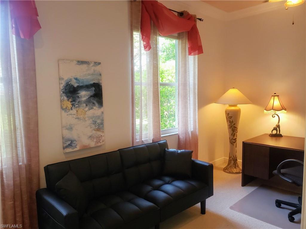 8906 Lely Island Circle Naples, FL 34113 - Photo 33 of 36 a living room with furniture and a window