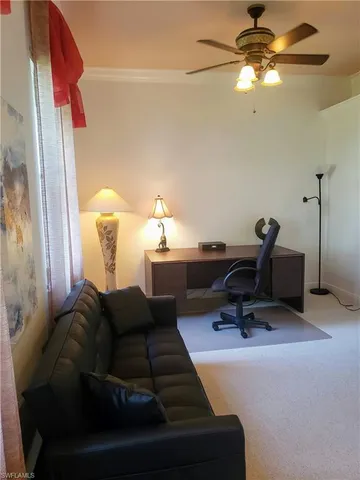 a living room with furniture a lamp and a window