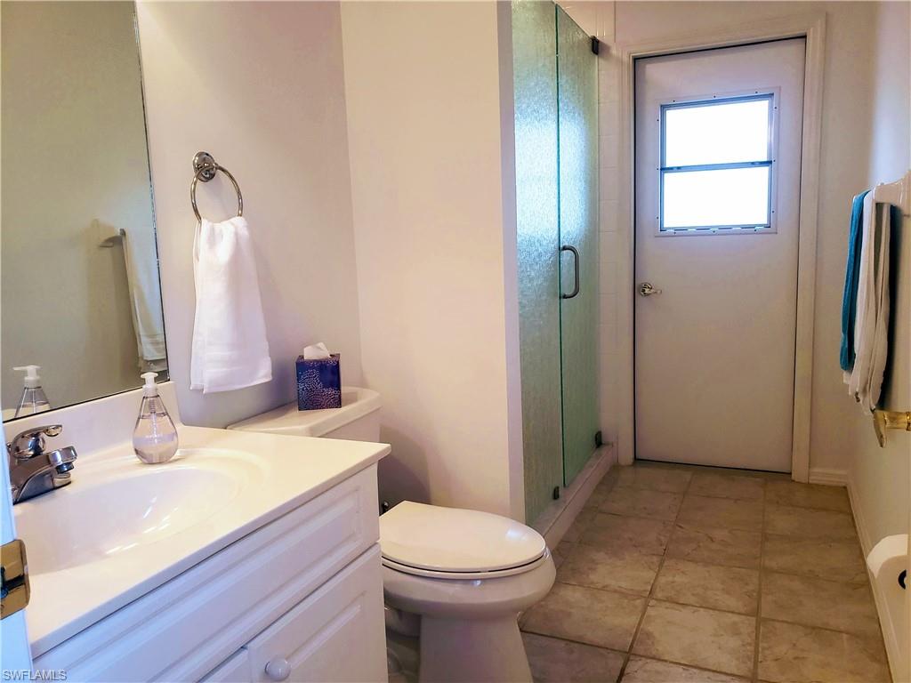 8906 Lely Island Circle Naples, FL 34113 - Photo 36 of 36 a bathroom with a sink a toilet and shower