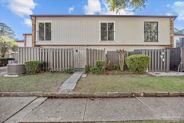 an aerial view of a house with a yard and outdoor seating