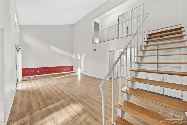 a view of entryway and hall with wooden floor
