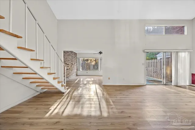 a view of entryway and hall with wooden floor