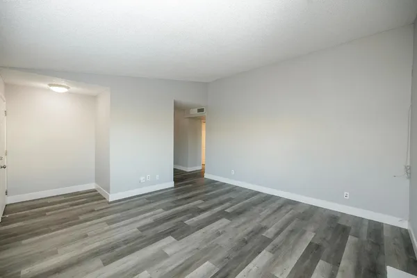 a view of an empty room and wooden floor