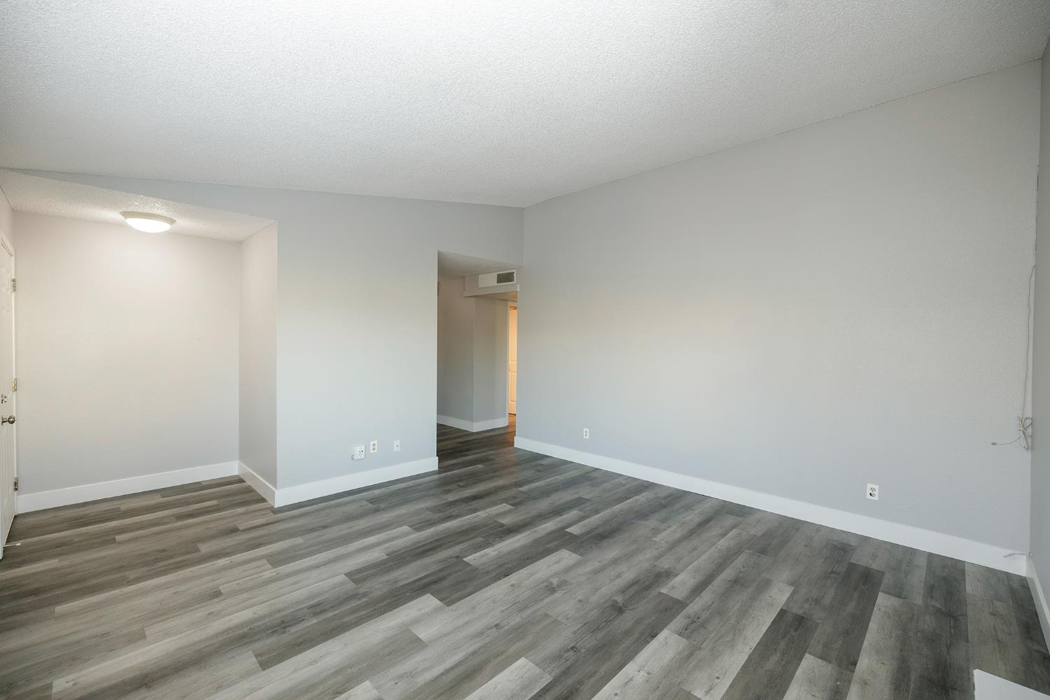 1313 Floyd Avenue, Unit 122 Modesto, CA 95355 - Photo 11 of 35 a view of an empty room and wooden floor