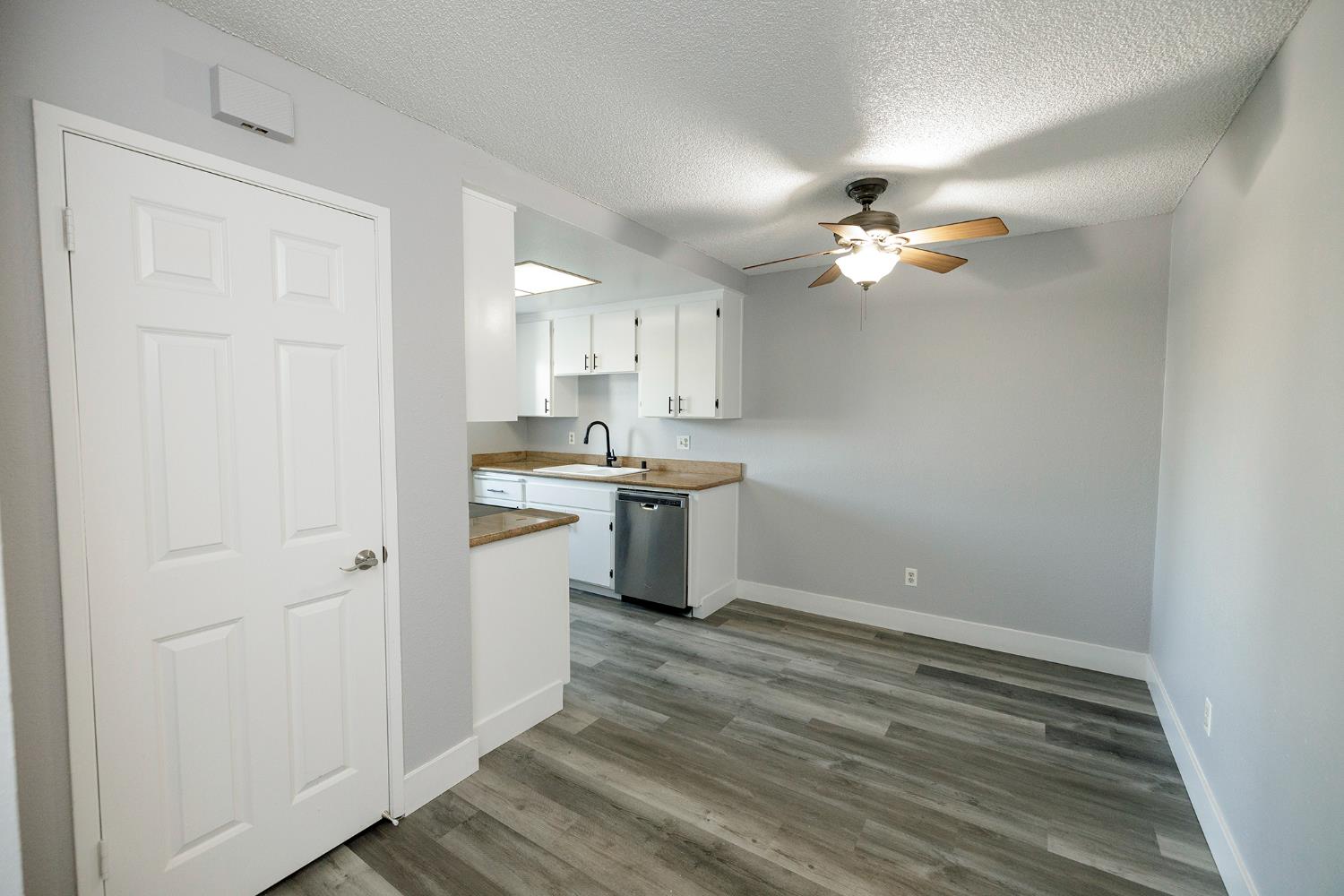 1313 Floyd Avenue, Unit 122 Modesto, CA 95355 - Photo 14 of 35 a kitchen with kitchen island a stove a sink and a refrigerator with wooden floor