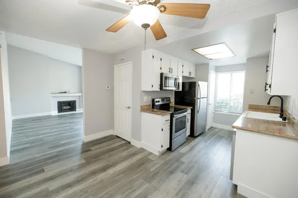 a kitchen with stove cabinets and wooden floor