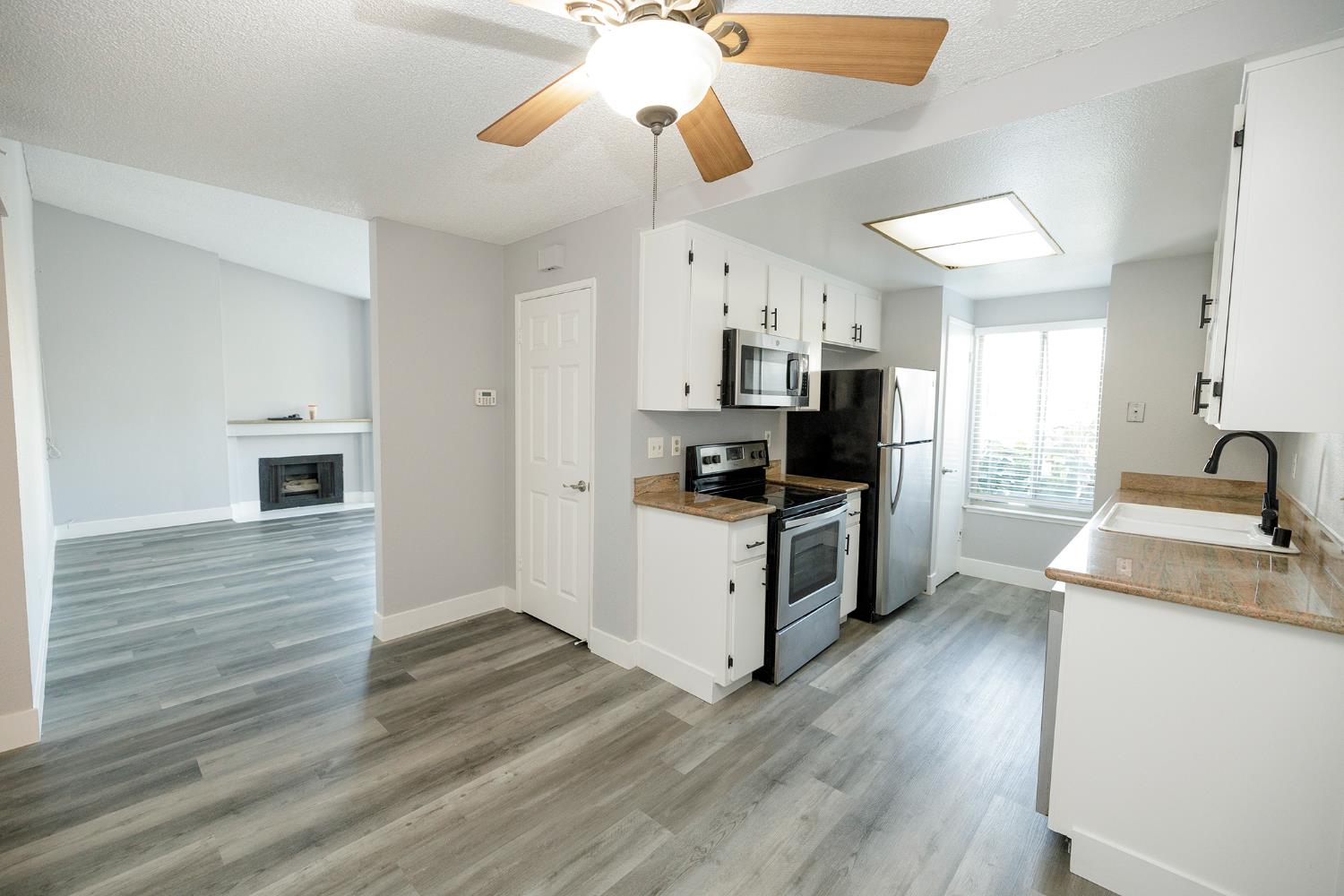 1313 Floyd Avenue, Unit 122 Modesto, CA 95355 - Photo 16 of 35 a kitchen with stove cabinets and wooden floor