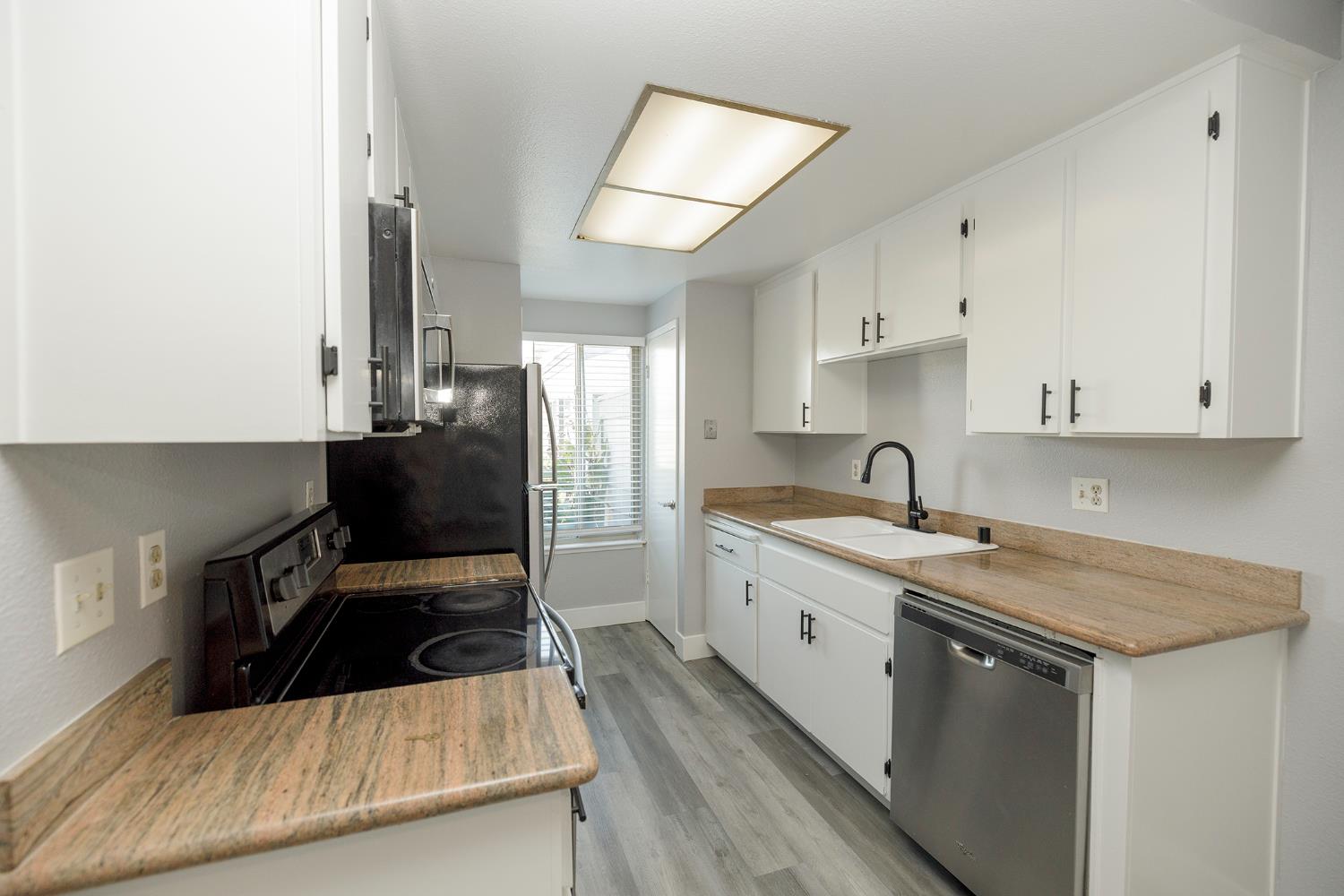 1313 Floyd Avenue, Unit 122 Modesto, CA 95355 - Photo 19 of 35 a kitchen that has a sink and a stove in it