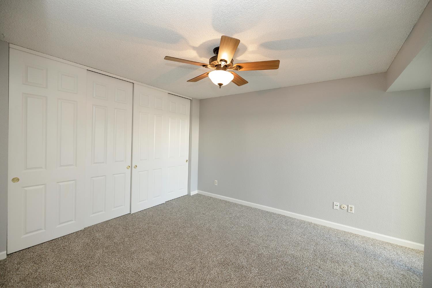 1313 Floyd Avenue, Unit 122 Modesto, CA 95355 - Photo 21 of 35 an empty room with closet and a chandelier fan
