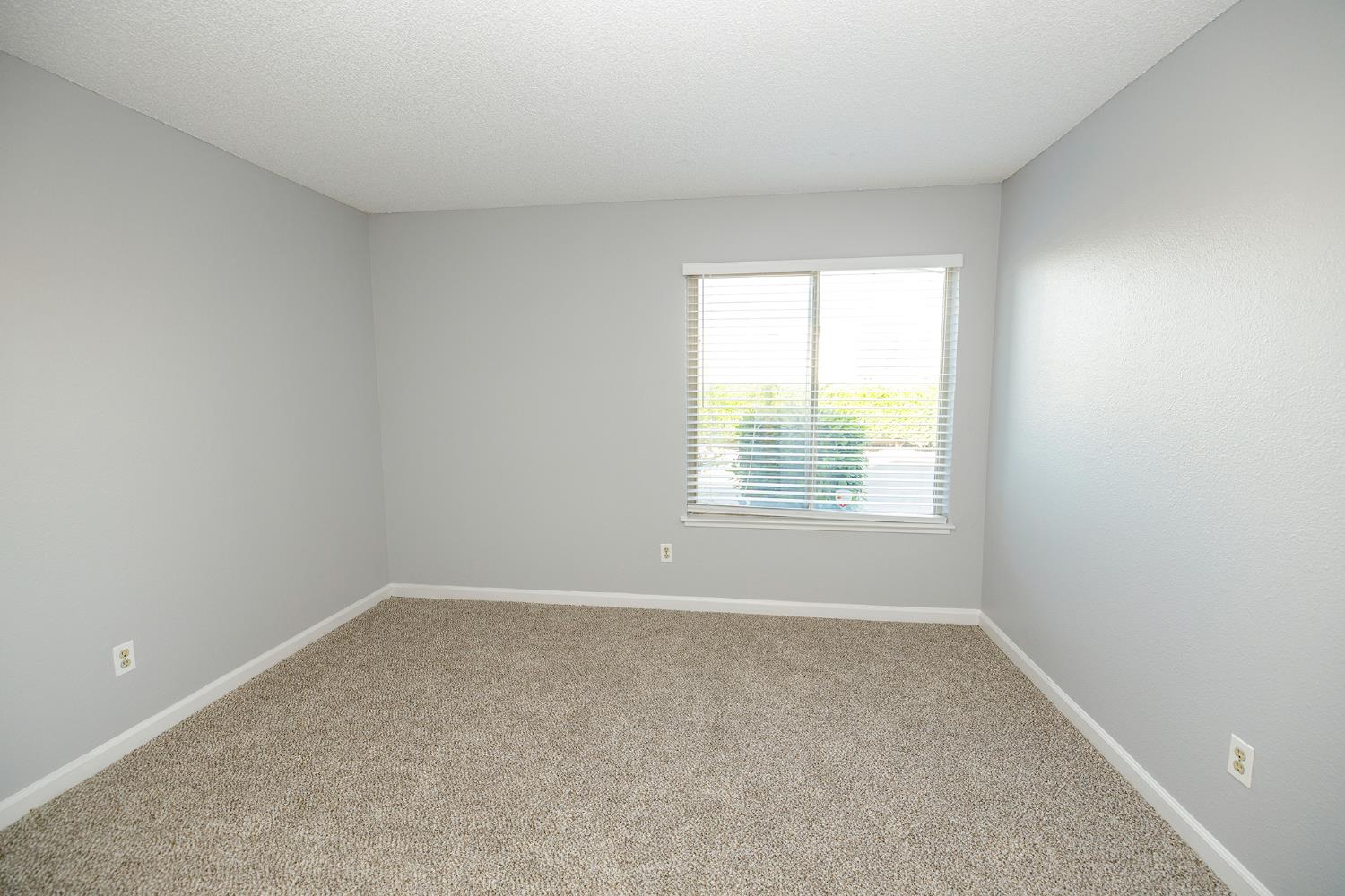 1313 Floyd Avenue, Unit 122 Modesto, CA 95355 - Photo 25 of 35 an empty room with a window