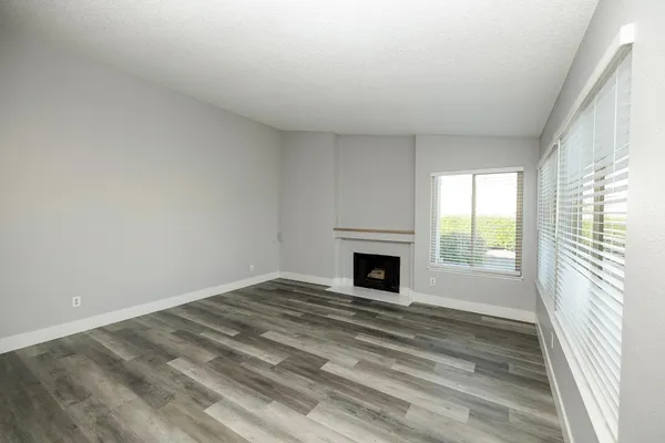 a view of empty room with fireplace