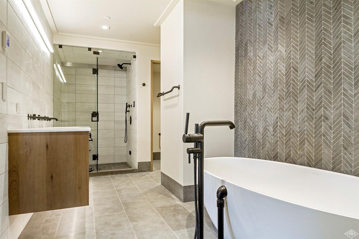 304 Bridge Street, Unit R3 Vail, CO 81657 - Photo 12 of 25 a bathroom with a sink a toilet a mirror and shower