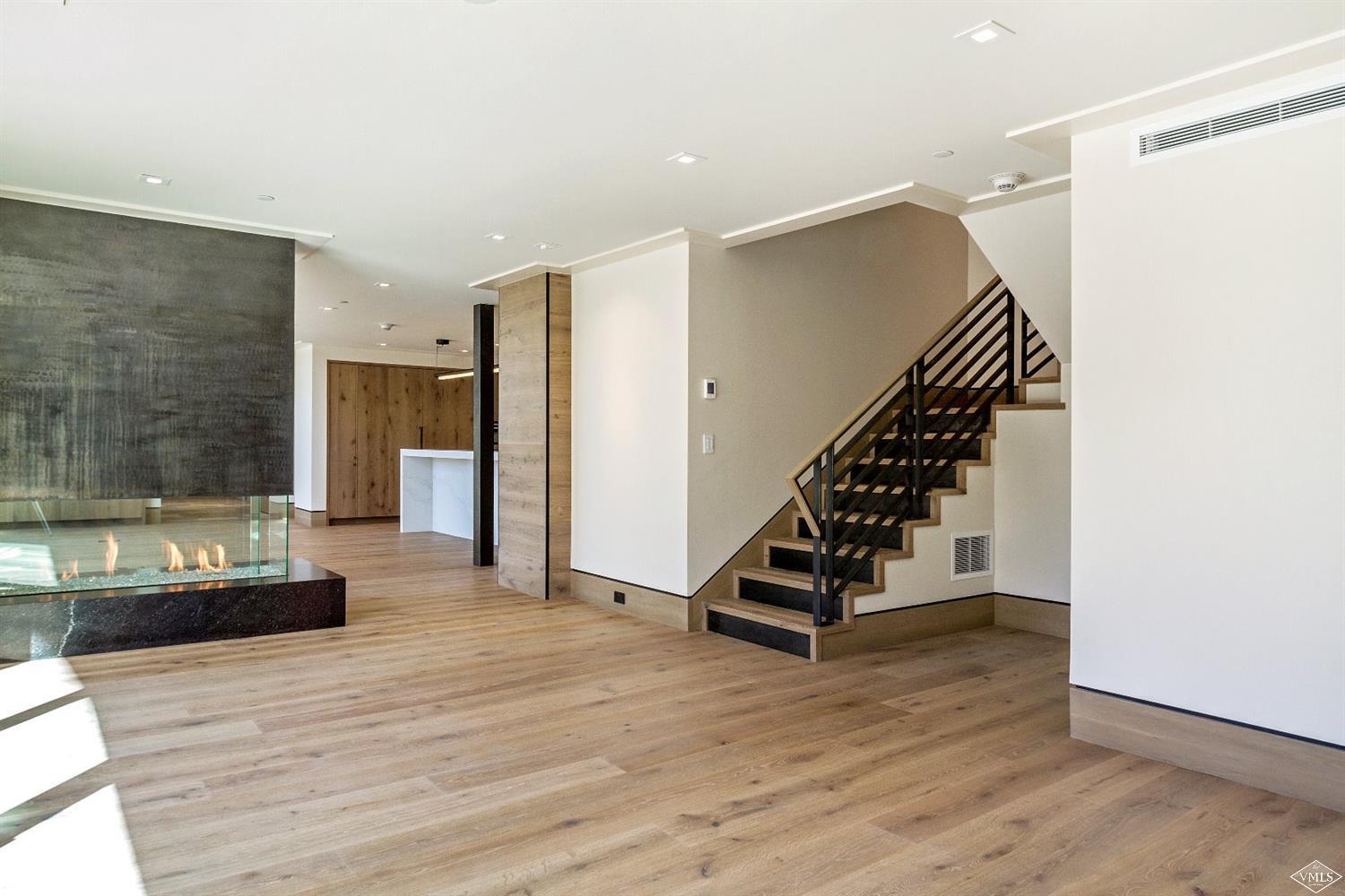 304 Bridge Street, Unit R3 Vail, CO 81657 - Photo 5 of 25 a view of a livingroom with wooden floor and stairs