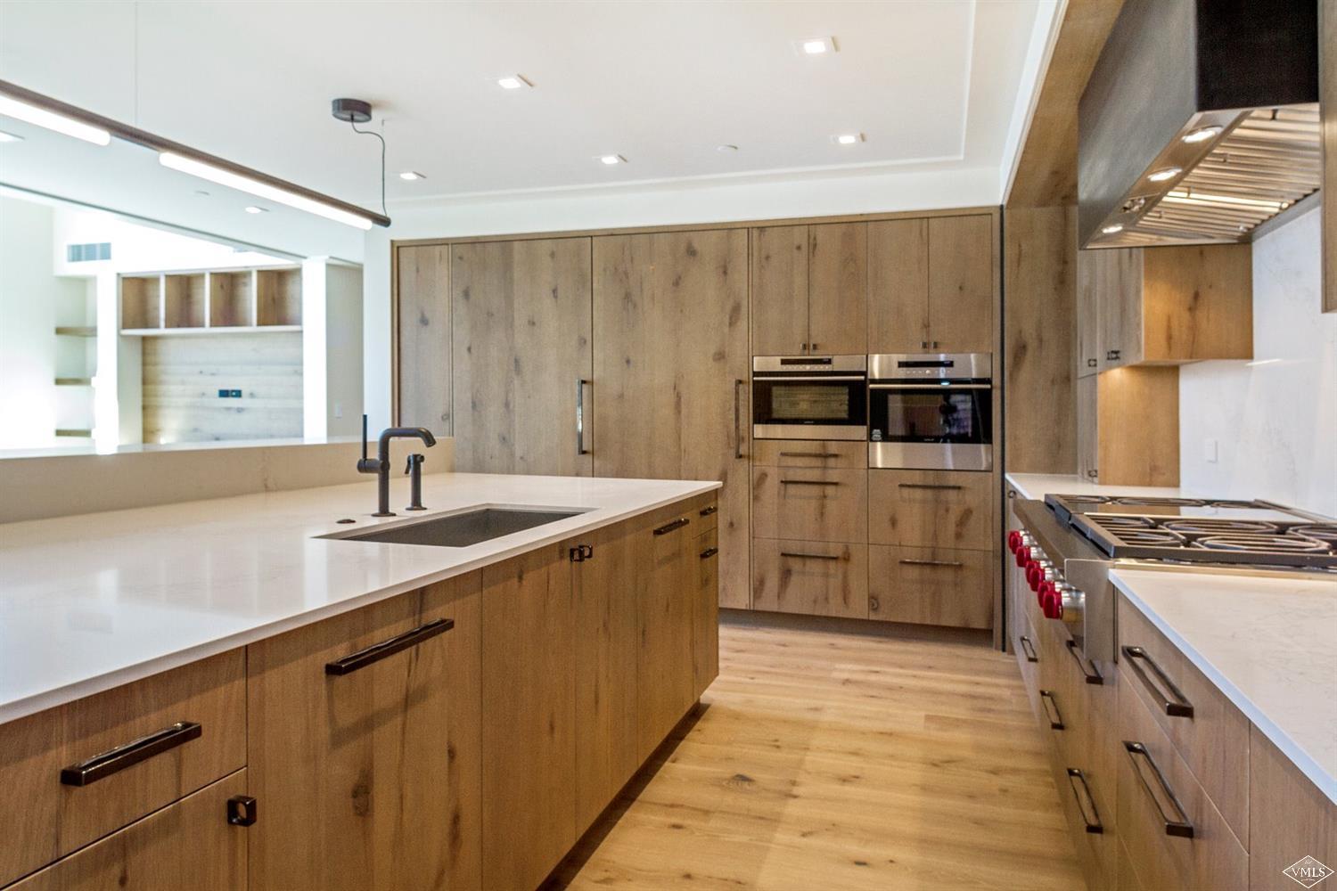 304 Bridge Street, Unit R3 Vail, CO 81657 - Photo 8 of 25 a kitchen with a sink stove and cabinets