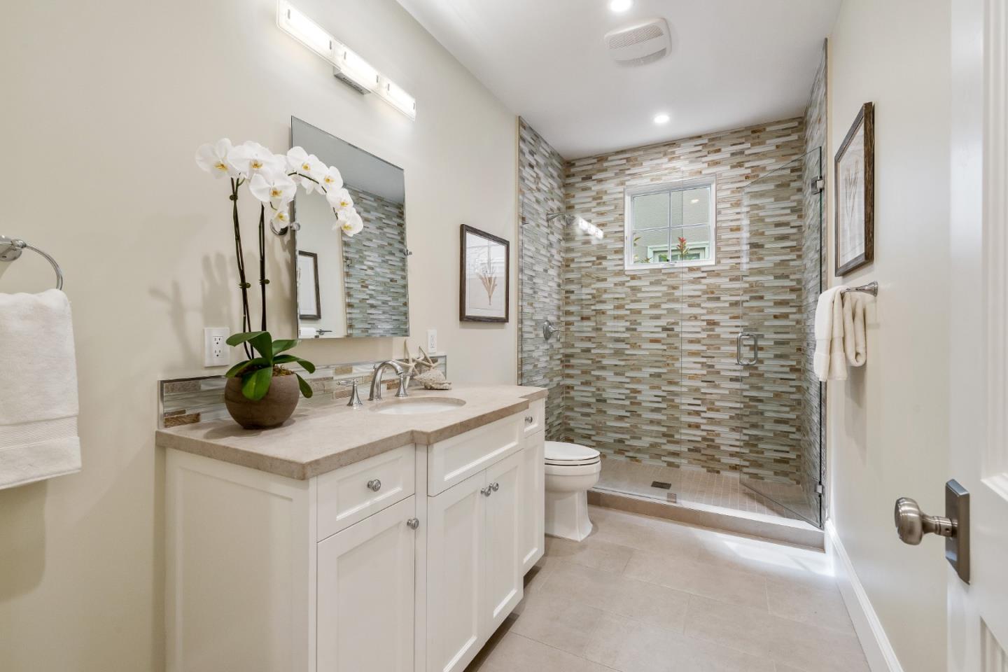115 Occidental Avenue Burlingame, CA 94010 - Photo 25 of 50 a bathroom with a granite countertop sink a toilet and shower