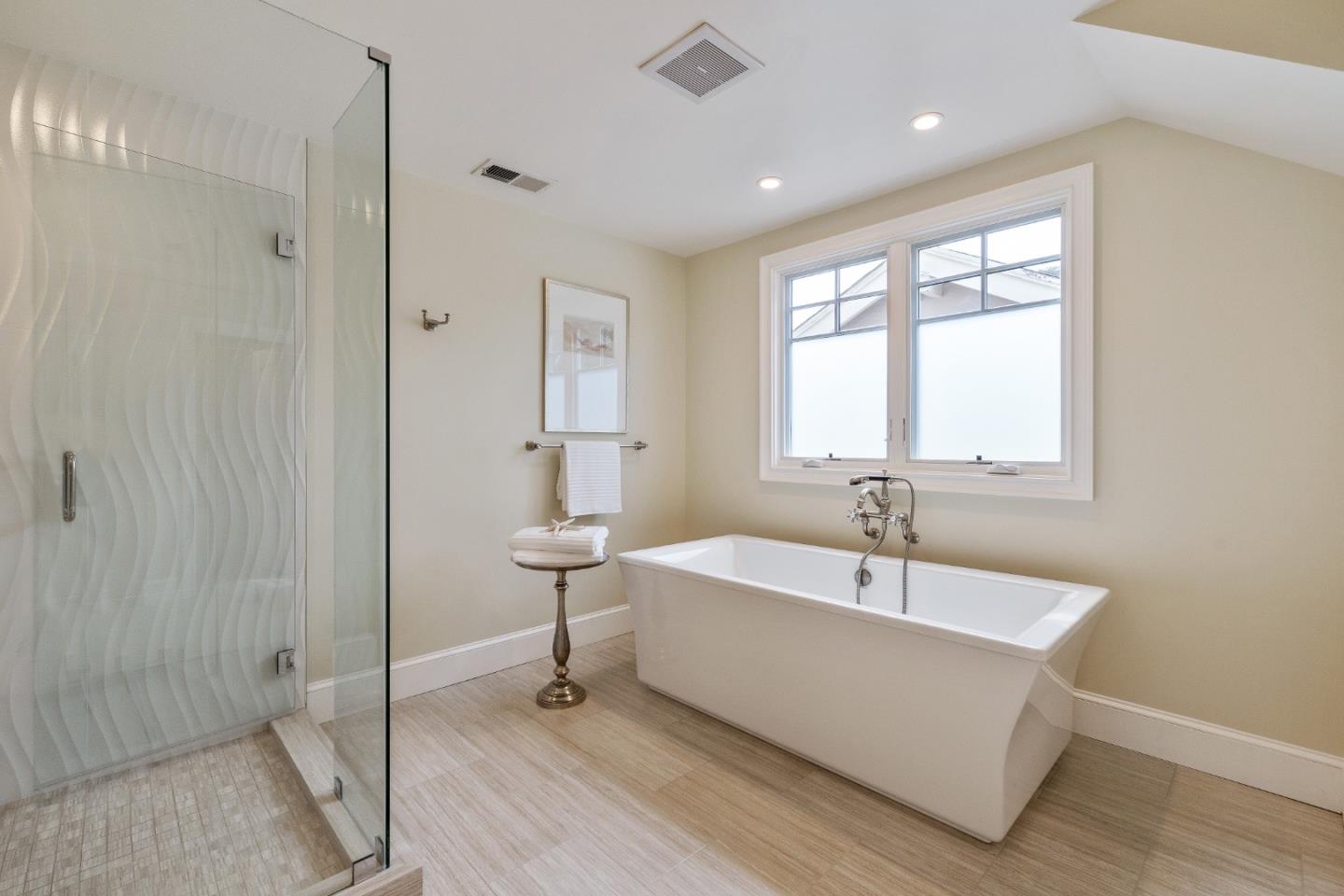 115 Occidental Avenue Burlingame, CA 94010 - Photo 38 of 50 a spacious bathroom with a bathtub and next to a window