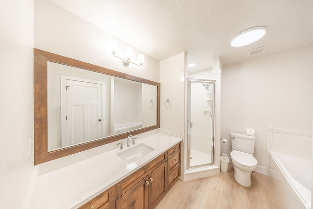 2169 Orchard Pines Loop East Bountiful, UT 84010 - Photo 12 of 32 Bathroom featuring a wood-finish vanity with a light-colored countertop, an undermount sink, and a large framed mirror