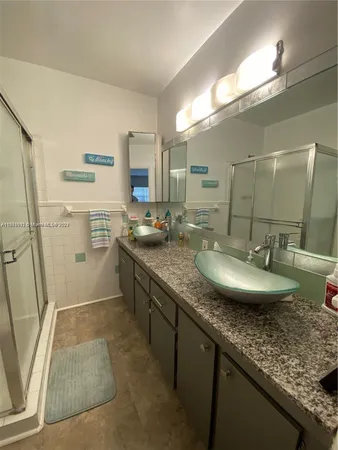 a house view with a sink and mirror