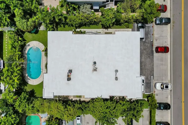 a view of a yard in front of a house with a garden