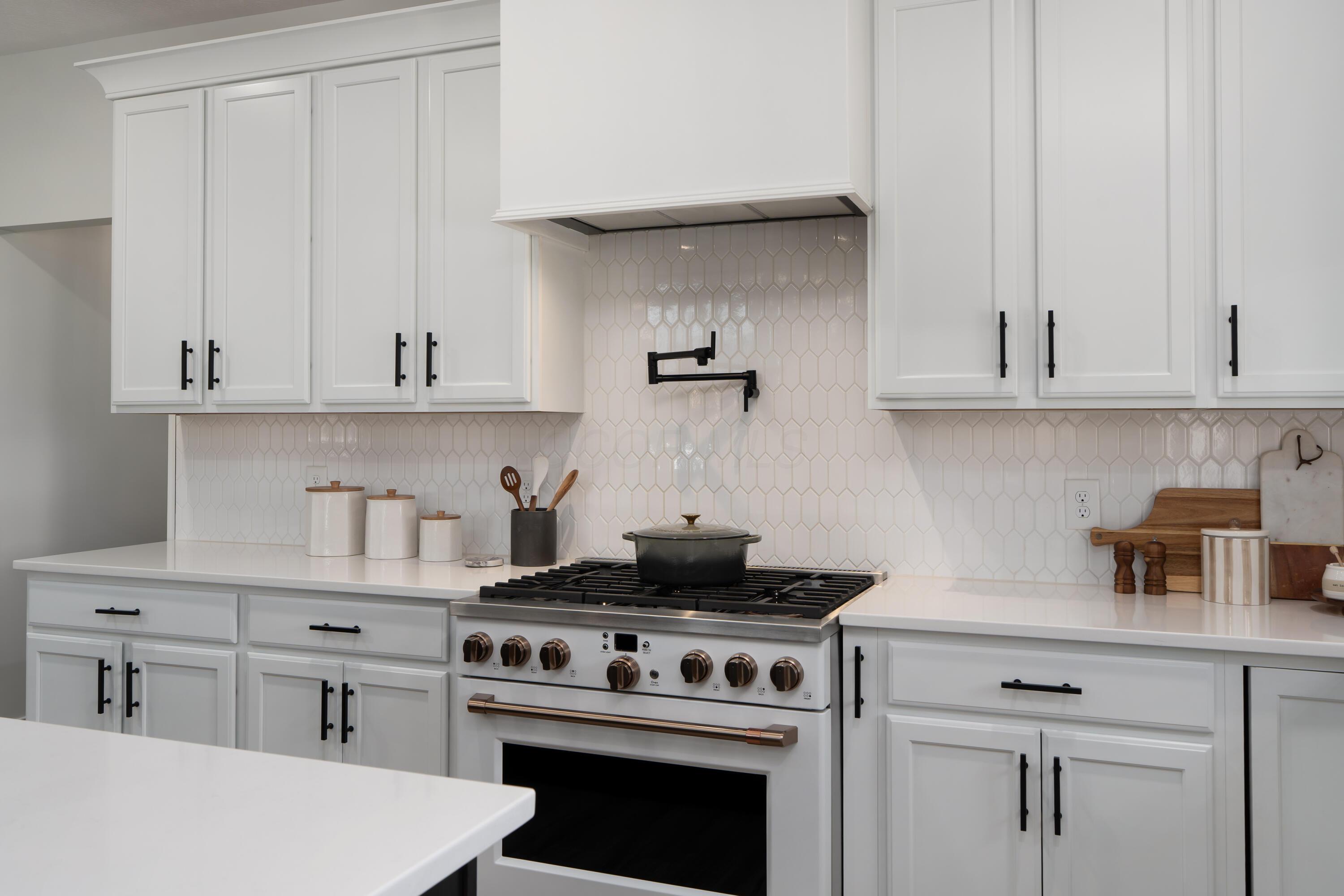 7308 Concord Road Delaware, OH 43015 - Photo 24 of 73 Kitchen with Gas Range with Custom Hood Detail and Tile Backsplash