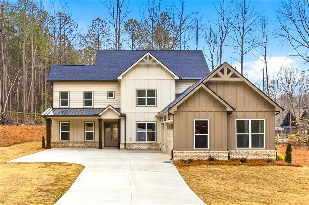 730 Primrose Lane Pendergrass, GA 30567 - Photo 1 of 40 a front view of a house with a yard and garage