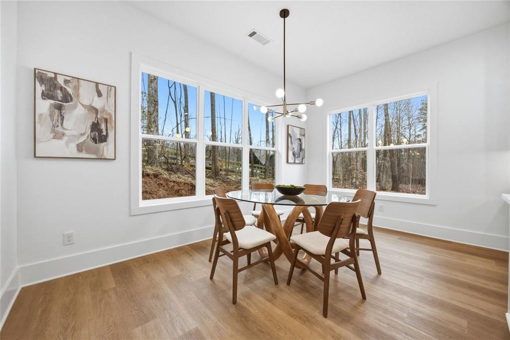730 Primrose Lane Pendergrass, GA 30567 - Photo 12 of 40 a view of a dining room with furniture window and wooden floor