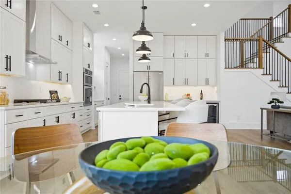 a kitchen with kitchen island stainless steel appliances a sink and a fireplace