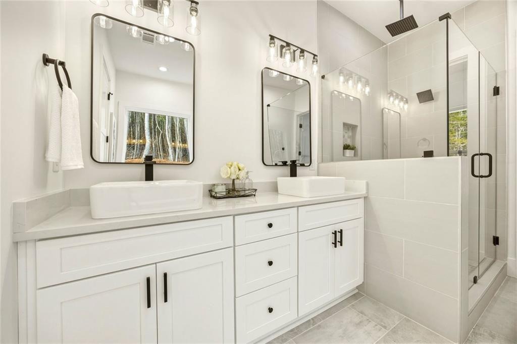 730 Primrose Lane Pendergrass, GA 30567 - Photo 19 of 40 a bathroom with double sink and a mirror