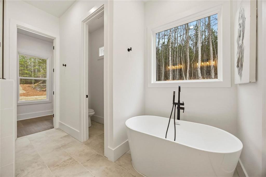 730 Primrose Lane Pendergrass, GA 30567 - Photo 21 of 40 a bath tub sitting in a bathroom next to a window