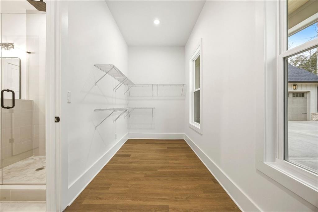 730 Primrose Lane Pendergrass, GA 30567 - Photo 22 of 40 a view of a hallway with wooden floor and staircase