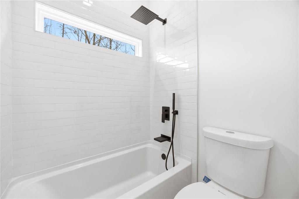 730 Primrose Lane Pendergrass, GA 30567 - Photo 29 of 40 a bathroom with a toilet and a bathtub