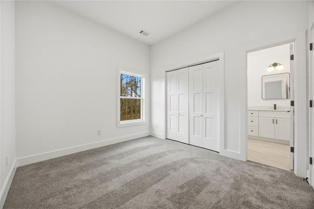 730 Primrose Lane Pendergrass, GA 30567 - Photo 31 of 40 an empty room with windows and cabinet